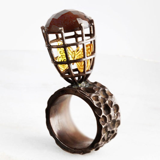 Handmade caged butterfly ring. Silver with 22k gold butterfly and gem stone on top of cage with Antique patina. This ring can be custom made in any ring size requested.