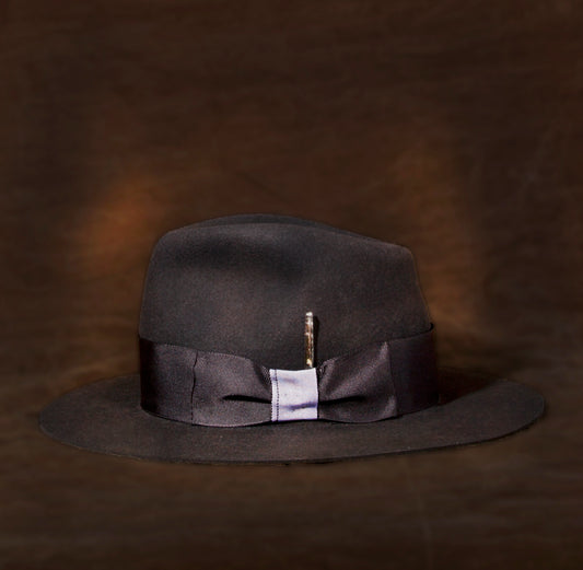 This fedora Stan Gaz Handmade 100% beaver fur felt, made in USA. Hand shaped, leather sweat band. Feather, silk lining, and custom patina. Hat is available in Medium. It can be custom made in whatever size needed.