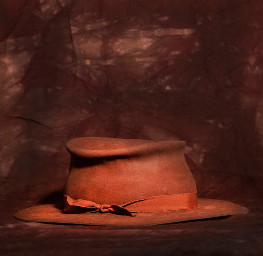 Beaver fur felt hand shaped with a branded leather sweat band. Silk lining and a custom look. After sanding I use fire, steam, dye, paint to distress.