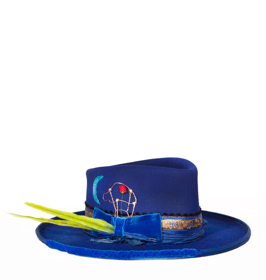 Bluebird is a 100% beaver fur felt custom made hat. Hand painted, vintage velvet hat band and leather sweat band with a silk lining. Inspired by a stepped on Champaign top holder I made a silver pin for the side of the hat.