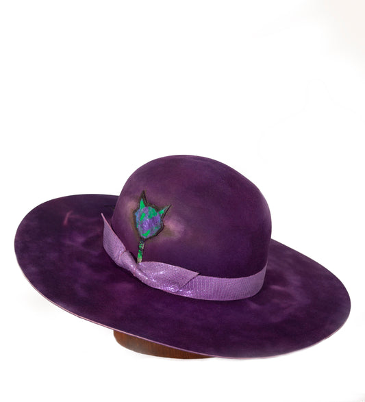 Purple Haze is a beautiful hand dyed hat thats 100% beaver fur felt. I alway's use the highest quality of materials. The hat band is a custom leather inspired by snake skin, Disco Snake. Theres a painted silver handmade hat pin shaped like a cat head. Silk and leather on the inside.