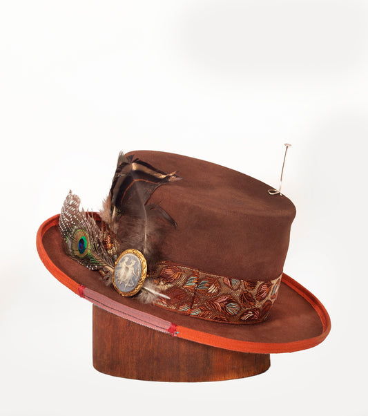 Rust Magic is a custom 100% beaver fur felt with a vintage brocade hat band. This hat has personalized objects that used on the hat that can not be reproduced. It was a collaboration commission. There is a silver antenna, leather branded sweat and silk lining.