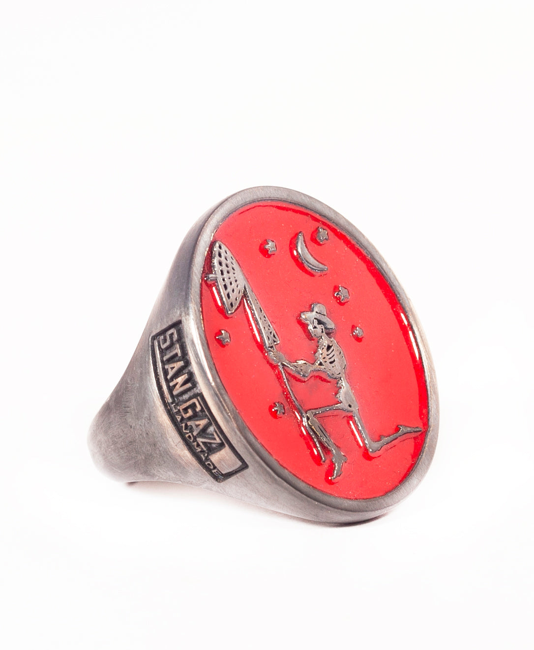 Silver skeleton signet ring with red enamel and logo.